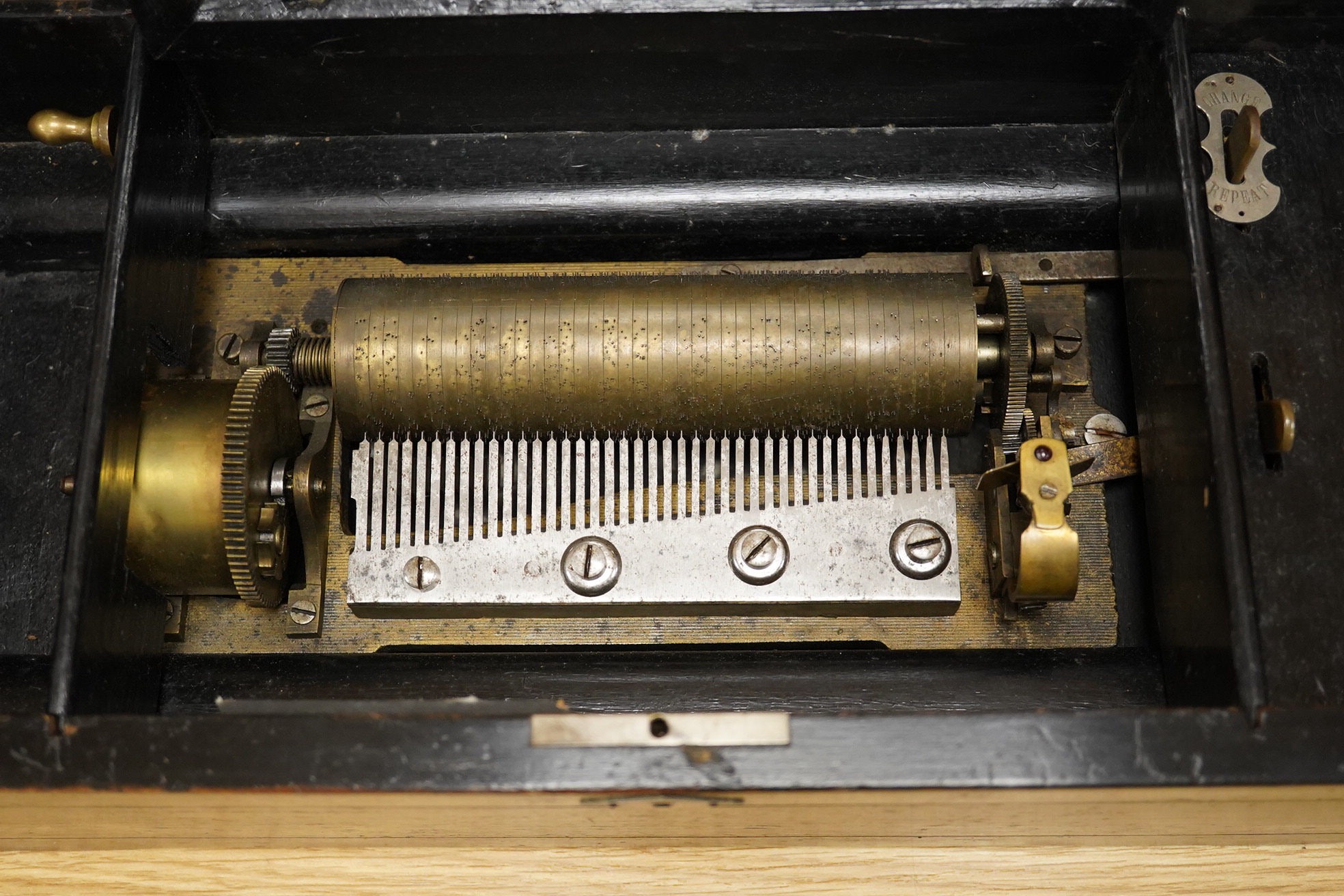 A mid-19th century inlaid and ebonised rosewood Swiss cylinder music box playing eight airs, card label to the inside of the lid listing the airs, complete with all teeth to the comb, cylinder 15.3cm long, the case; 43cm